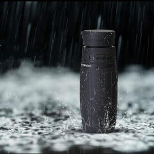 Eyeskey 8x25 monocular in heavy rain, showing its nitrogen-sealed waterproof body